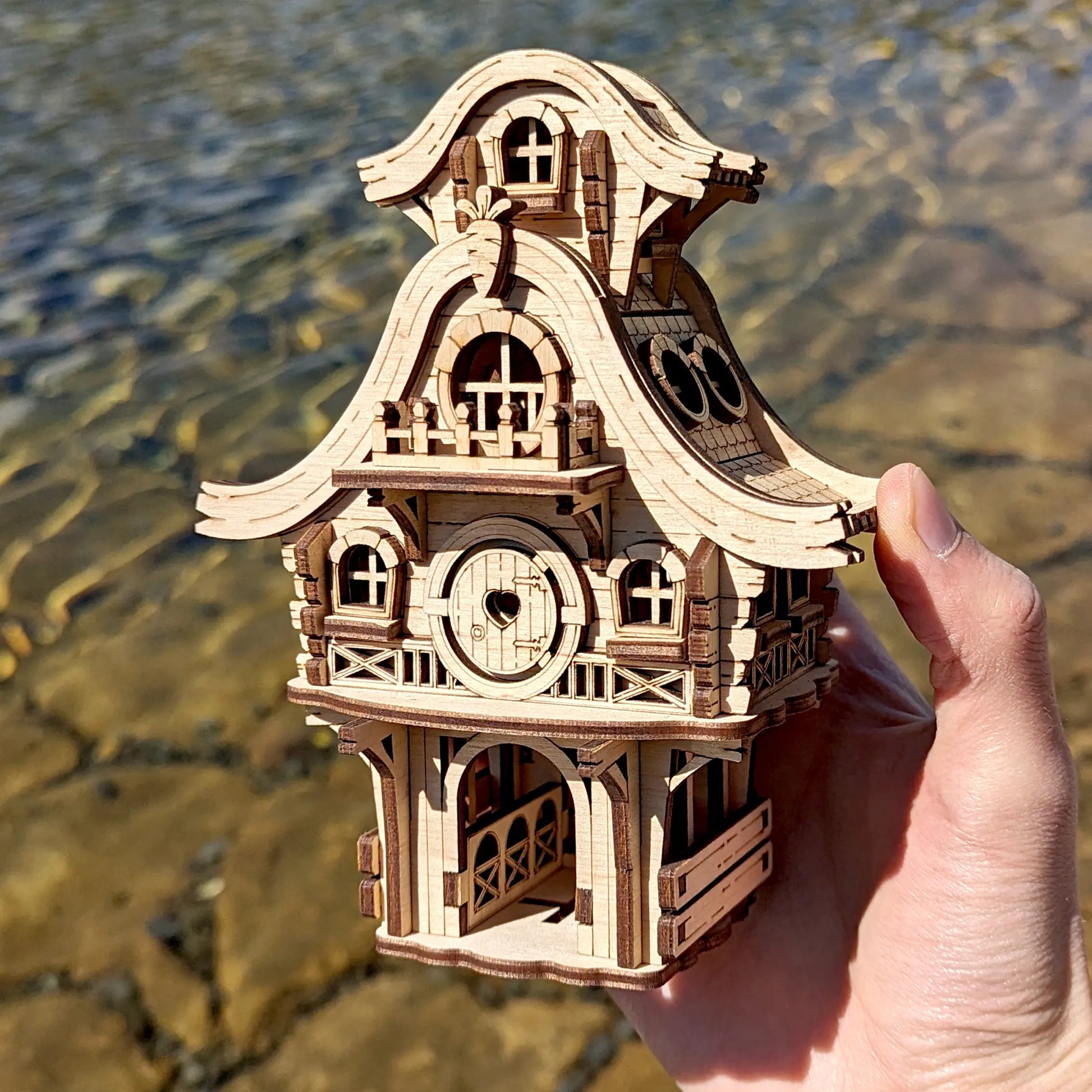Front view of a tiny laser cut plywood easter bunny cabin hidden in high green grass during a bright sunny spring morning.