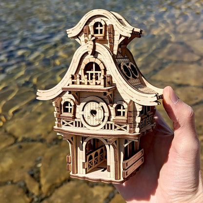 Front view of a tiny laser cut plywood easter bunny cabin hidden in high green grass during a bright sunny spring morning.