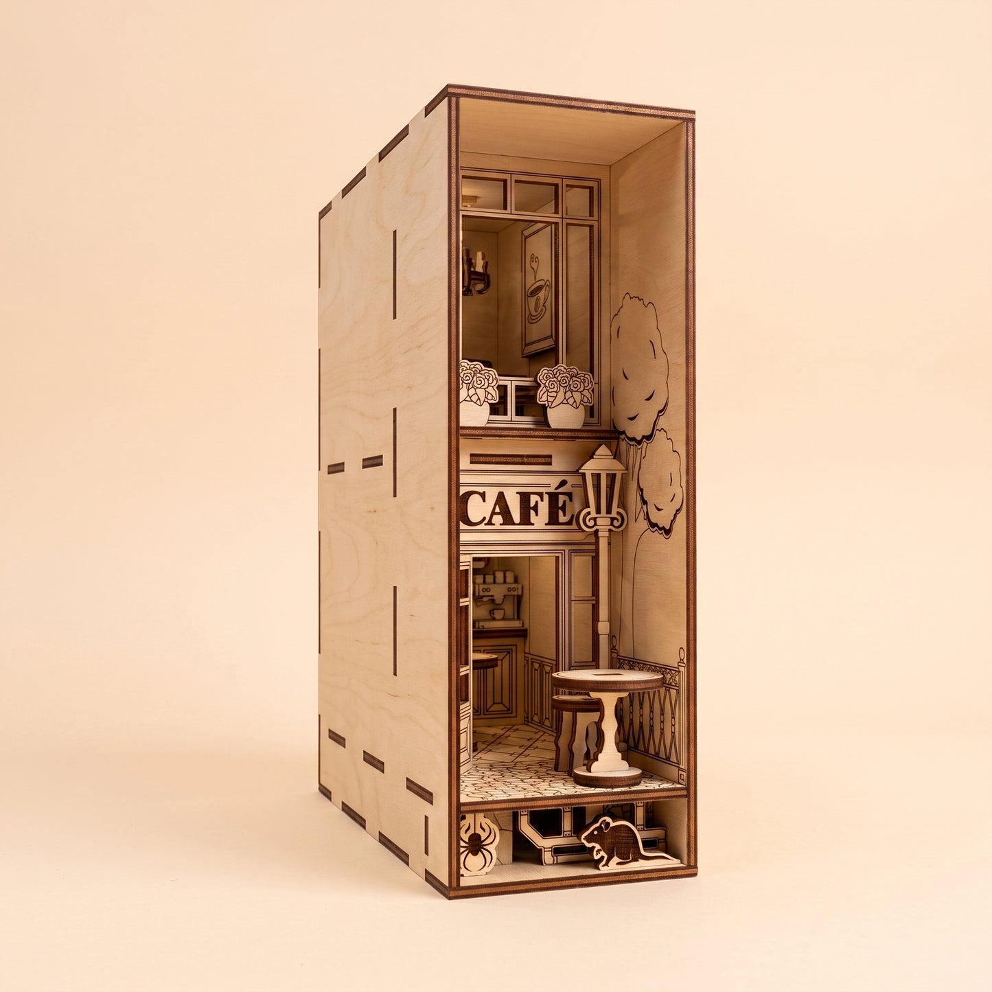 A detailed, unlit miniature café book nook crafted from laser cut plywood, showcasing its architectural features.