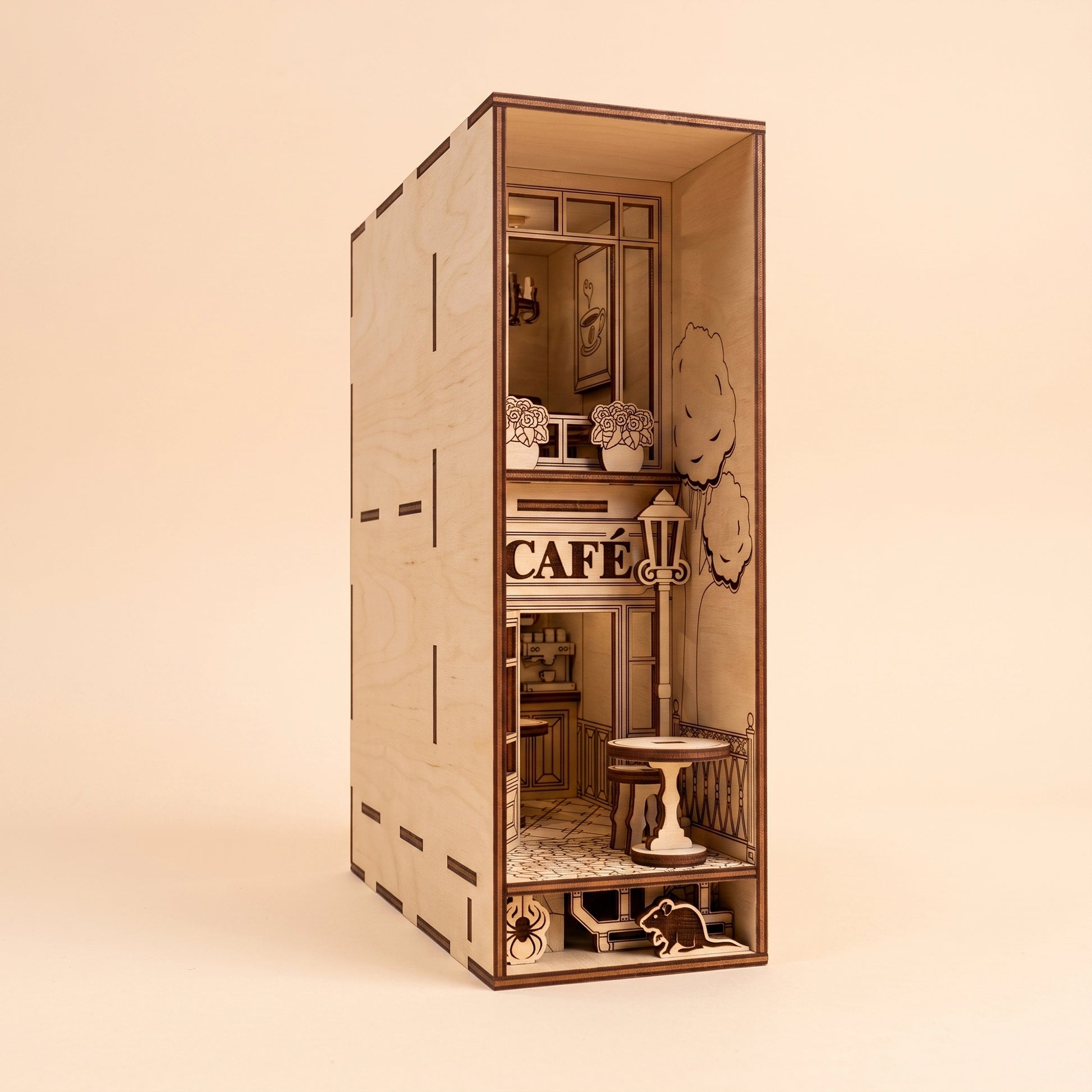 A detailed, unlit miniature café book nook crafted from laser cut plywood, showcasing its architectural features.