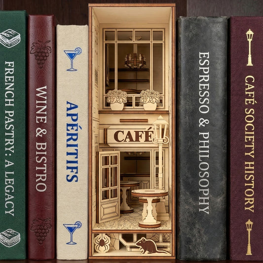 Detailed laser cut wooden Café Book Nook featuring a miniature storefront and street lamp, set between themed books with a dark bookshelf background.