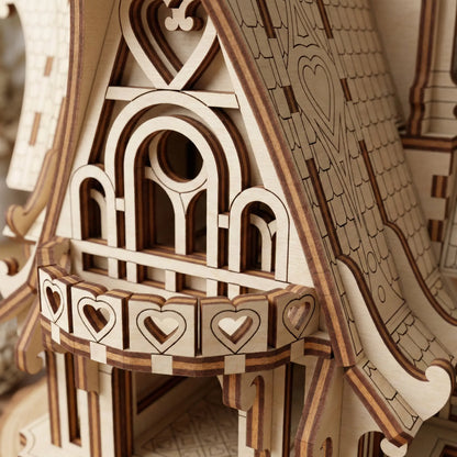 Wooden laser cut model of a detailed architectural structure with decorative elements.