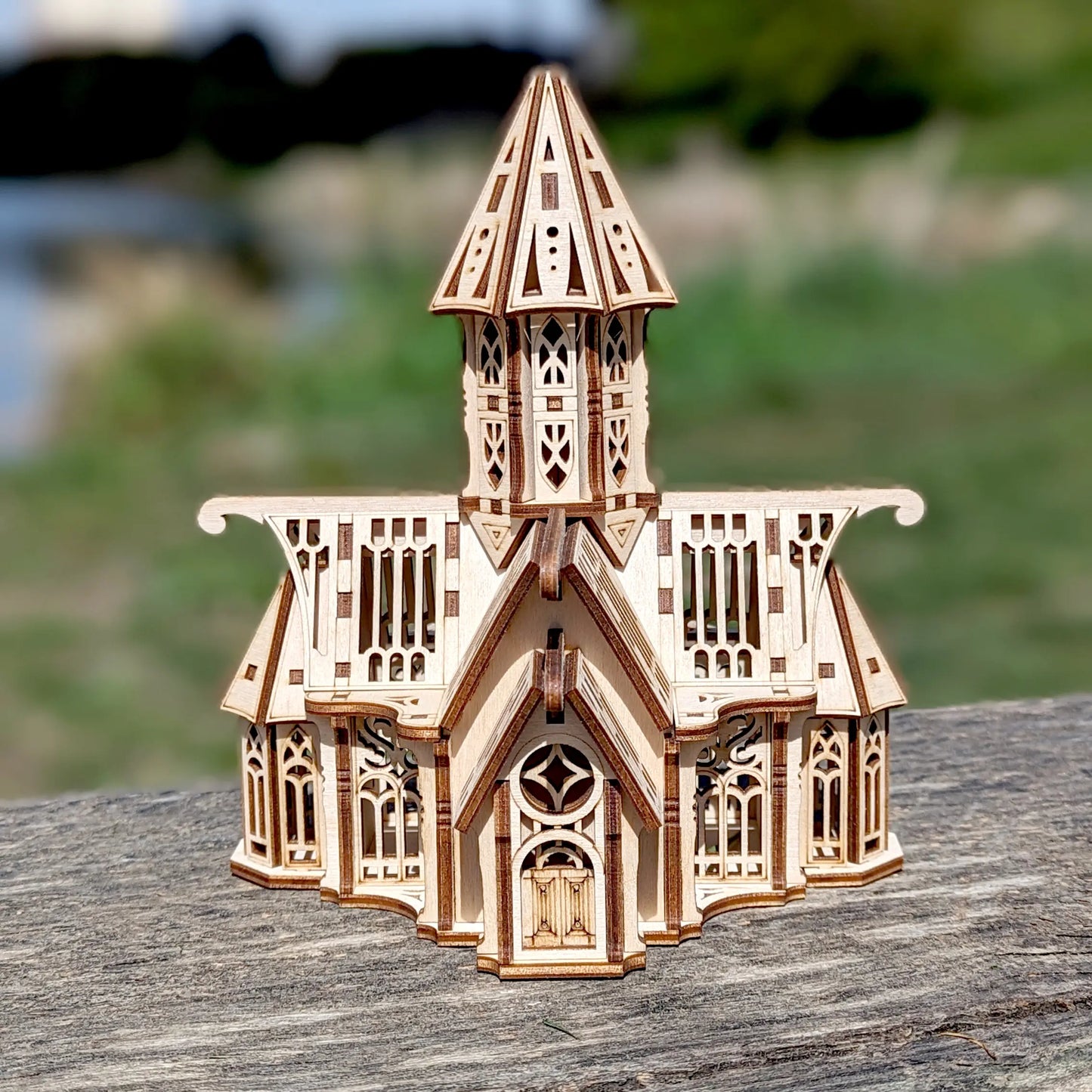 Straight perspective of a miniature gothic chapel made of laser cut plywood, beautifully focused with natural bokeh.