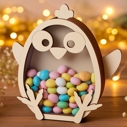 Laser cut plywood wooden chicken coin bank or candy box, filled with colorful pastel Easter chocolate eggs, sitting on a rustic table with soft, golden fairy lights and baby's breath flowers in the warm background.