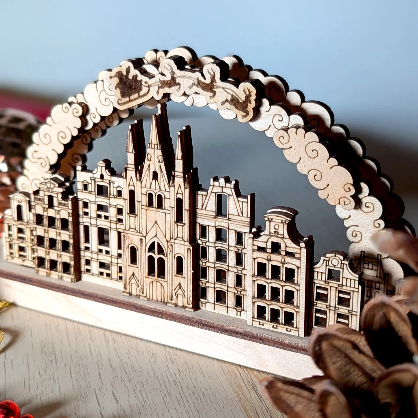 Angled perspective close-up showing the layered city town houses of a Christmas arch crafted from premium laser cut plywood.