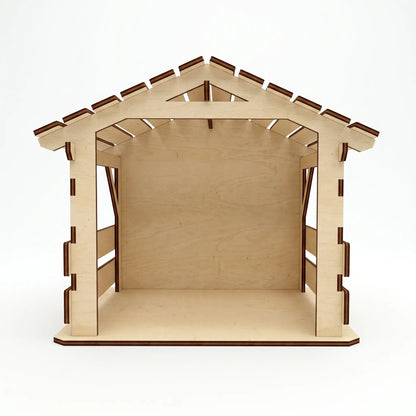 Front view of empty assembled laser cut plywood nativity stable barn with slotted wood roof on white background.