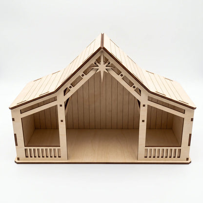 Front direct shot of empty laser cut plywood nativity stable showing open stalls isolated on white background.
