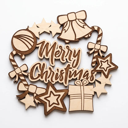 Detailed view of detached laser cut plywood Merry Christmas wreath ornament with festive bell, bow, and gift