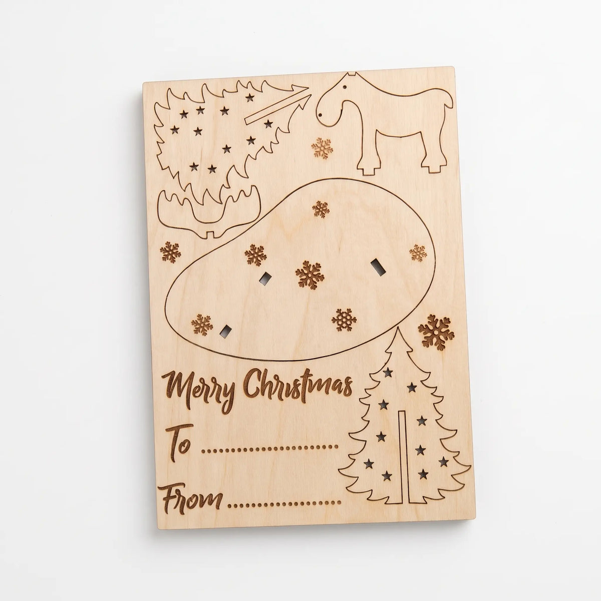 Flat laser cut plywood Christmas greeting card kit showing pop-out moose, tree parts, and address lines.