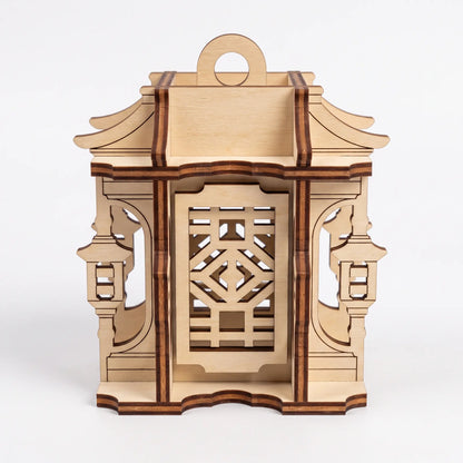 Front view of unfinished 3D laser cut plywood pagoda lantern featuring geometric fretwork windows on white background.