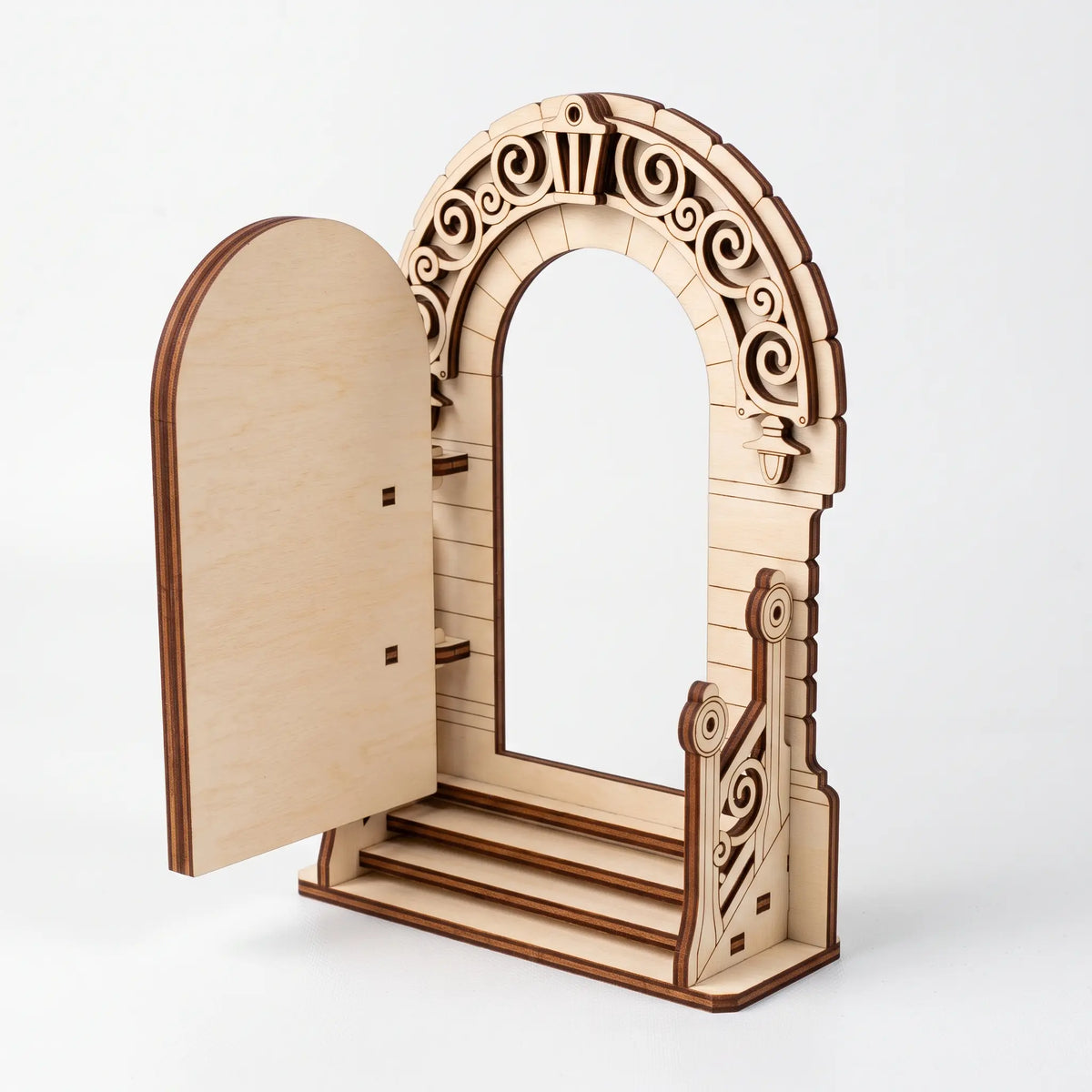 Isometric view of open laser cut plywood fairy door archway showing front steps and ornate banister on white backdrop.