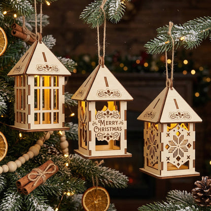 A set of three laser-cut plywood Christmas lanterns showing various designs: snowflake cutouts, a "Merry Christmas" greeting, and a traditional lattice style. The ornaments are hanging on a tree against a warm, blurred fireplace background.