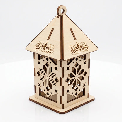 Unlit laser cut plywood lantern with carved snowflake patterns and floral roof details on white surface.