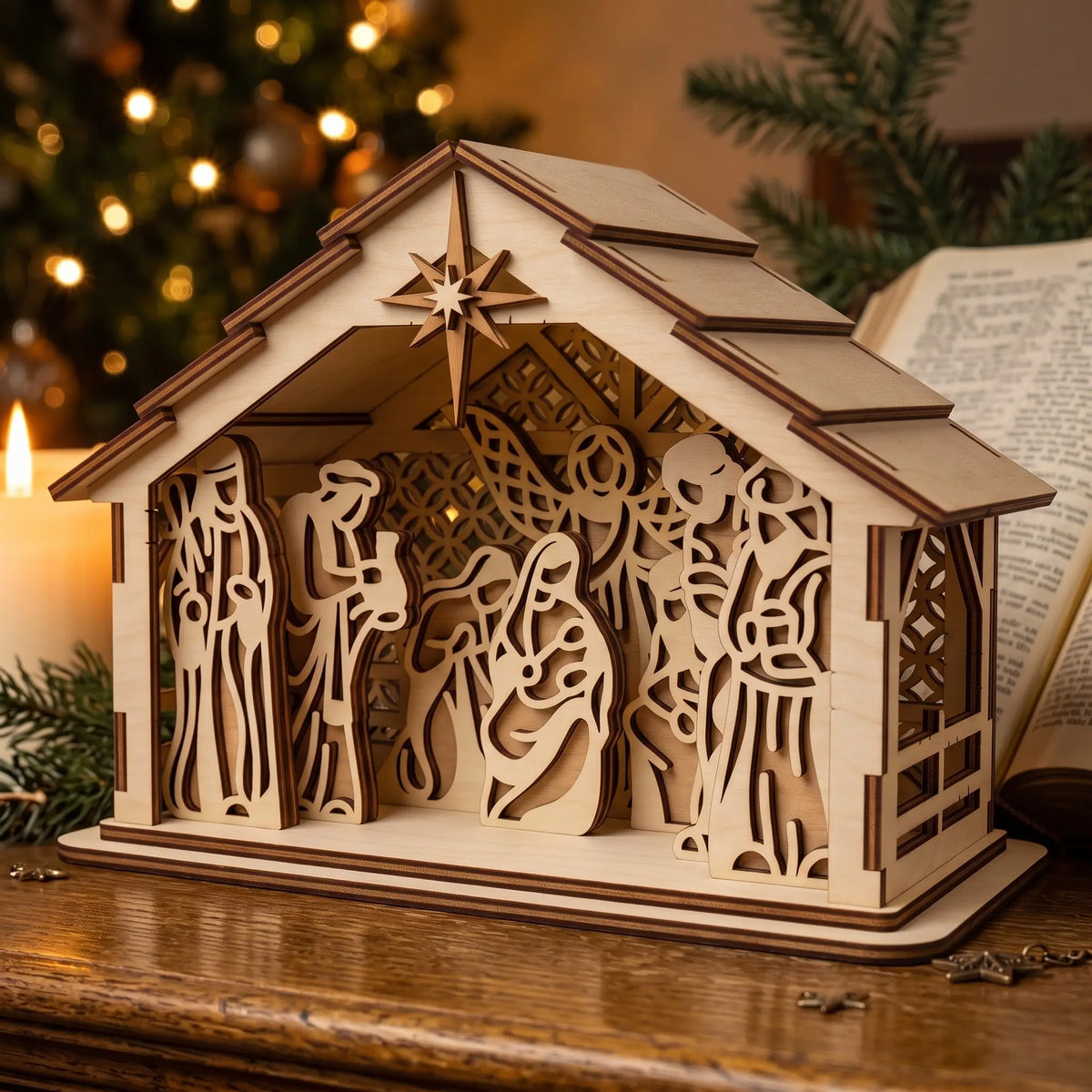Cozy laser cut plywood nativity stable with Bethlehem star on wooden table by candle and open Bible.