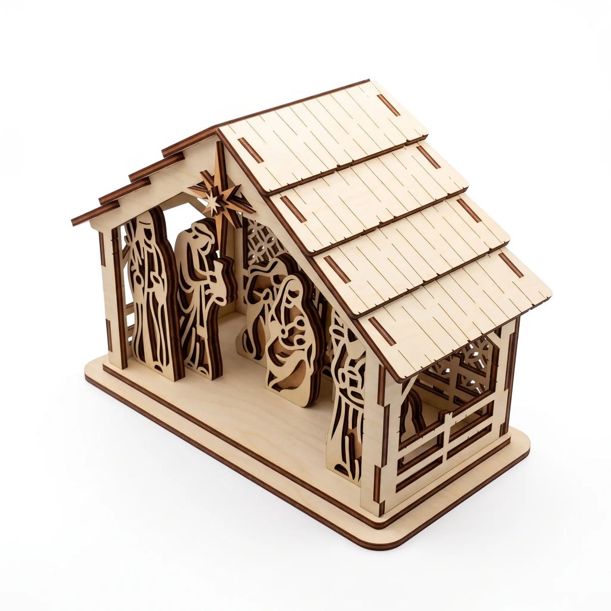 High-angle view of assembled laser cut plywood nativity stable with plank roof on white background.