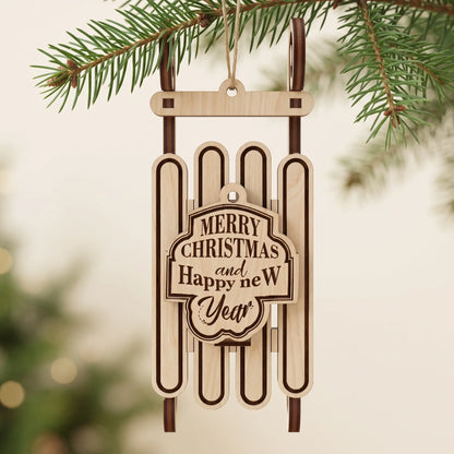 Direct view of laser cut plywood sled ornament engraved with Merry Christmas, hanging from pine branch.