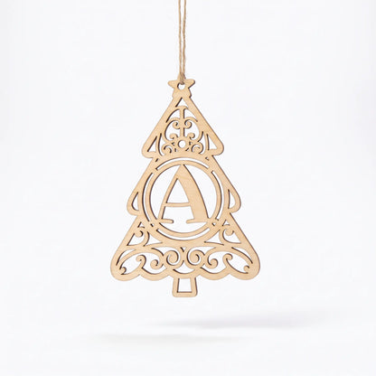 Laser cut plywood Christmas tree ornament with letter A monogram and ornate filigree swirls hanging against white background.