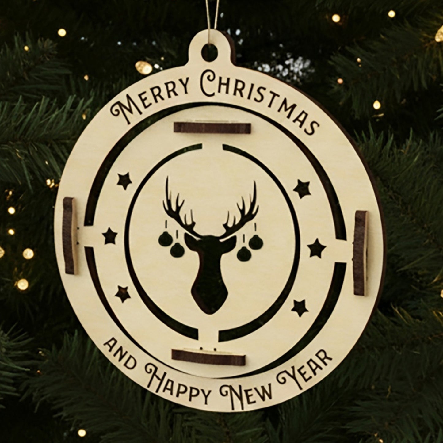 Laser cut wooden Christmas tree Ornament animal deer with a spinning reindeer head wearing ornament earrings inside a festive engraved circle, displayed against a warm twinkling Christmas tree background.
