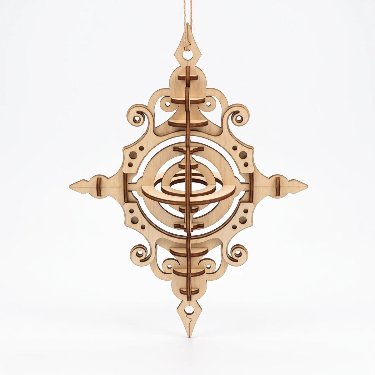 Frontal view of 3D layered laser cut plywood ornament showing rotating internal rings isolated on plain white.