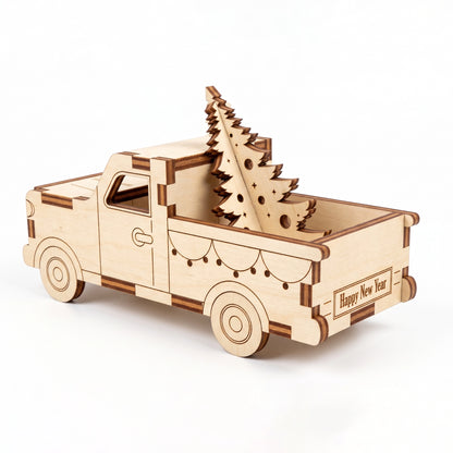 Rear three-quarter view of laser cut plywood pickup truck carrying wooden pine tree on white background