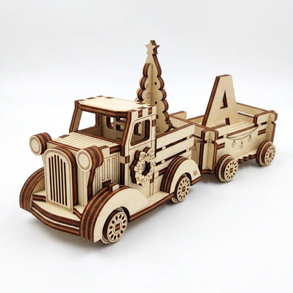 3D laser cut plywood vintage holiday pickup truck carrying a pine tree and trailer with wooden letter A on white background.