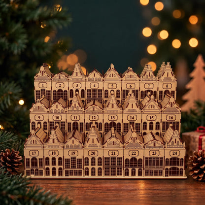Three-tier laser cut plywood Christmas village advent calendar with numbered house boxes beside fairy lights.