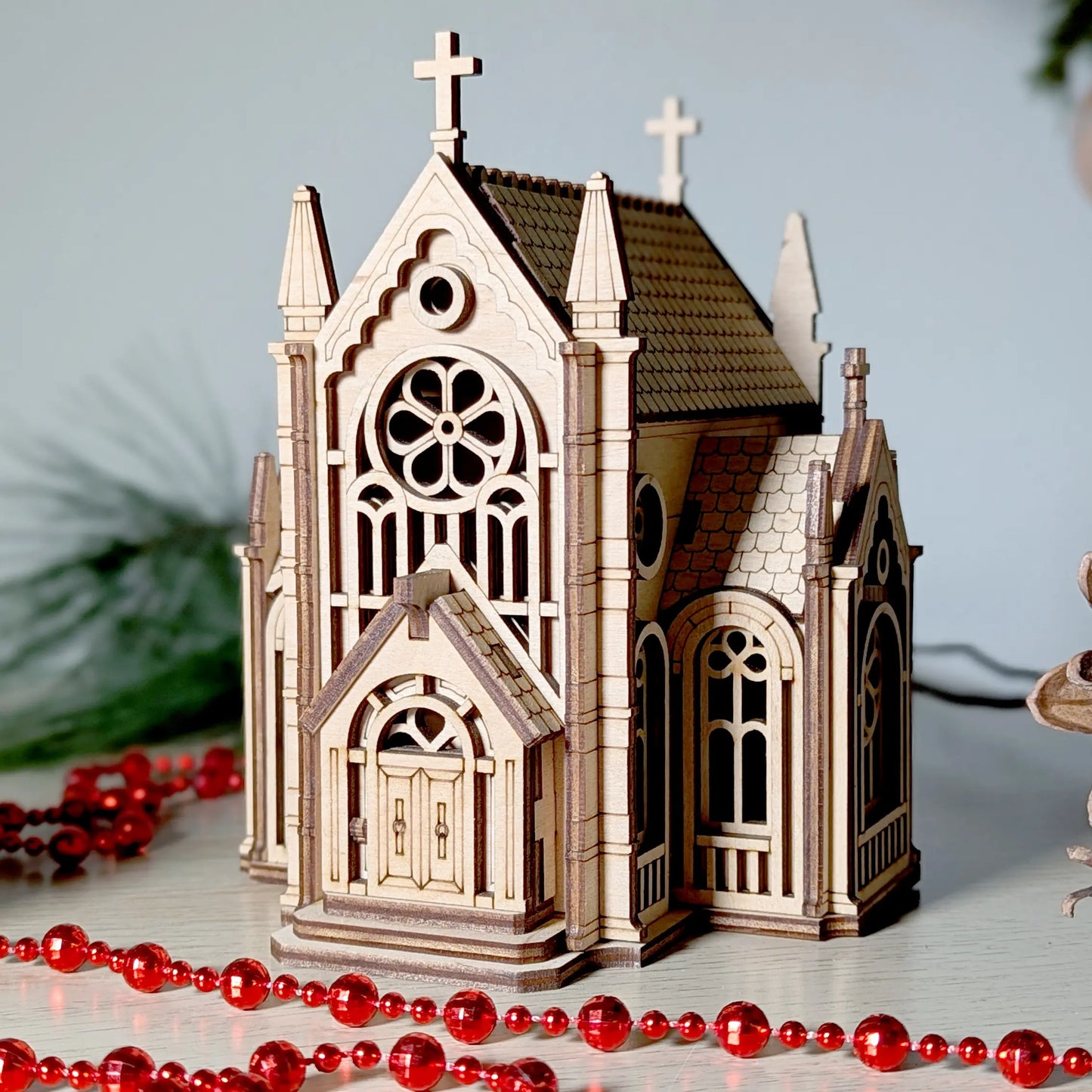 Detailed front-perspective product view of a gothic cathedral building model styled with beads and laser cut plywood.