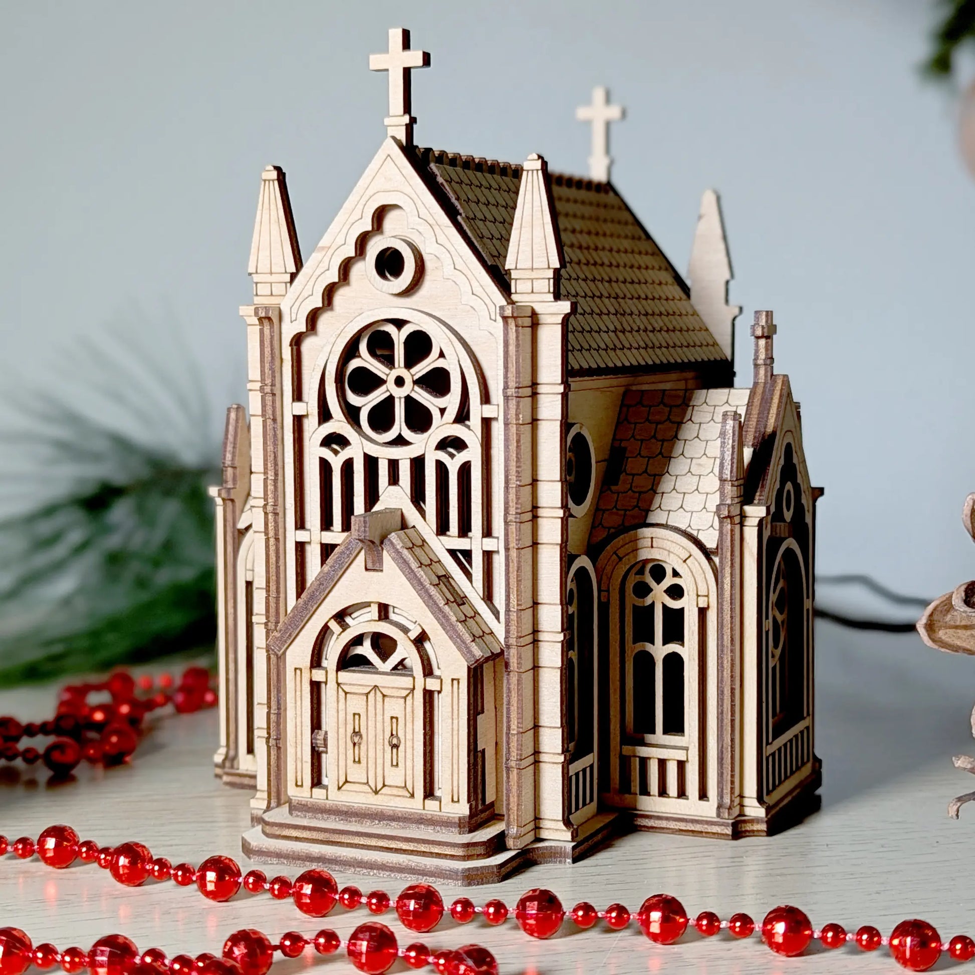 Detailed front-perspective product view of a gothic cathedral building model styled with beads and laser cut plywood.
