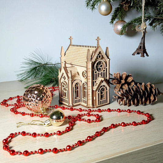 Beautiful high-angle holiday lifestyle shot of a miniature cathedral centerpiece beautifully made of laser cut plywood.