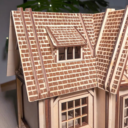 Detailed macro view of engraved brick shingle roof and a dormer window on a miniature laser cut plywood country house.