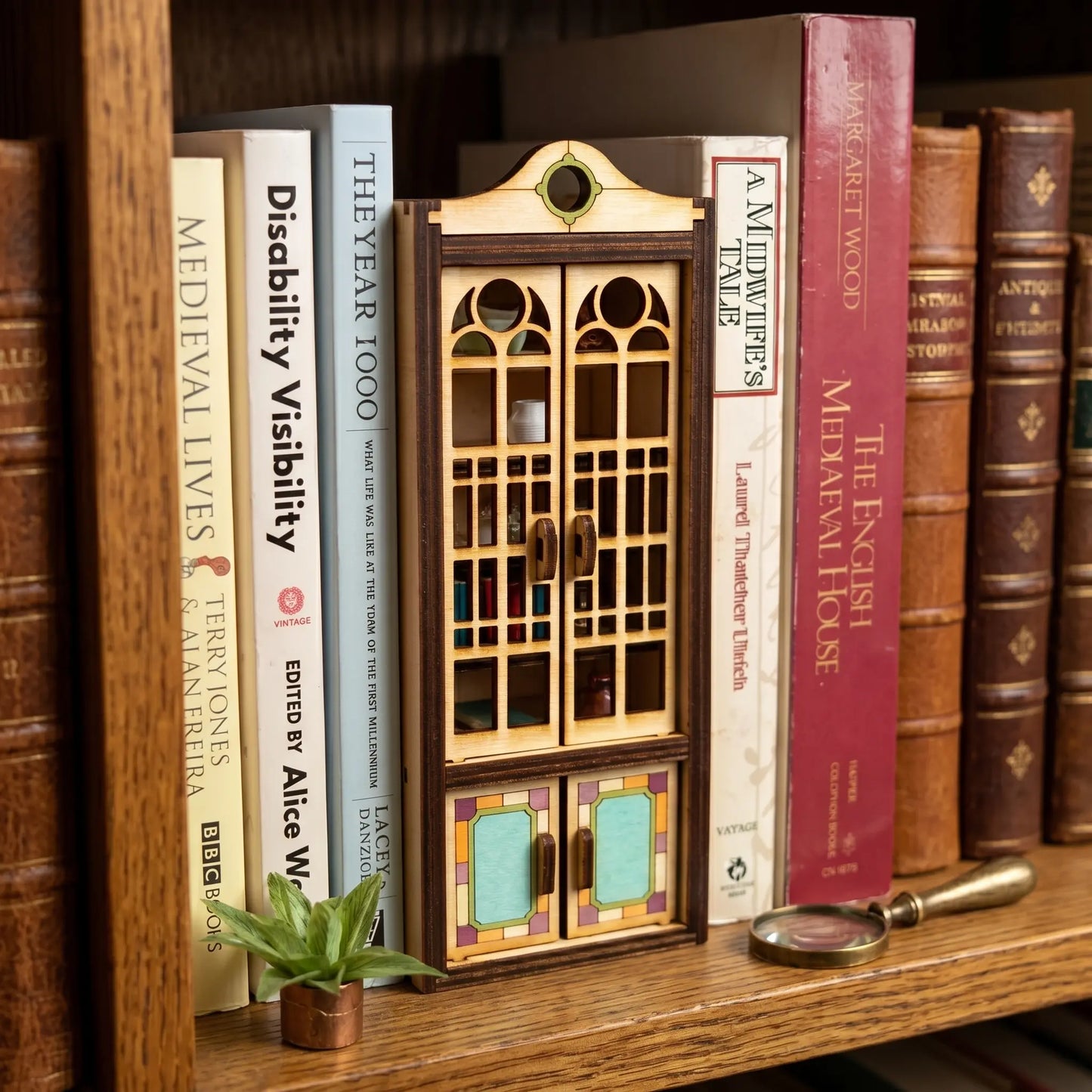 Wooden cupdoard blaser cut book nook with books on the shelf
