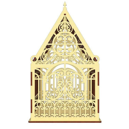 A decorative wooden structure with an intricate, ornate design featuring a pointed roof and a central archway.