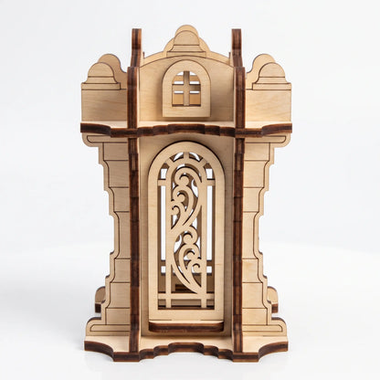 Front view of 3D laser cut plywood tower lantern featuring ornamental arch window and battlements on plain white backdrop.