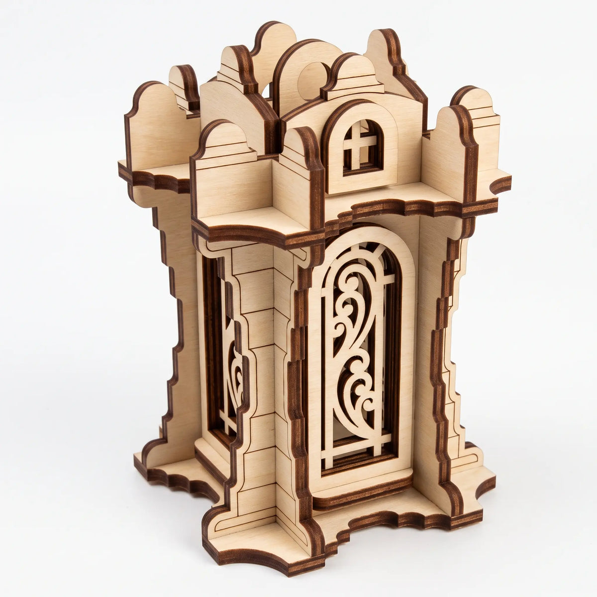 Isometric view of 3D laser cut plywood tower lantern with filigree arched panels and battlements on plain white background.