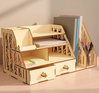 Front view of a multi-tier laser cut plywood desk shelf. Organized with notebooks, sticky notes, and folders. Highlights the precise interlocking joinery and decorative laser-etched scrollwork on the side support walls.
