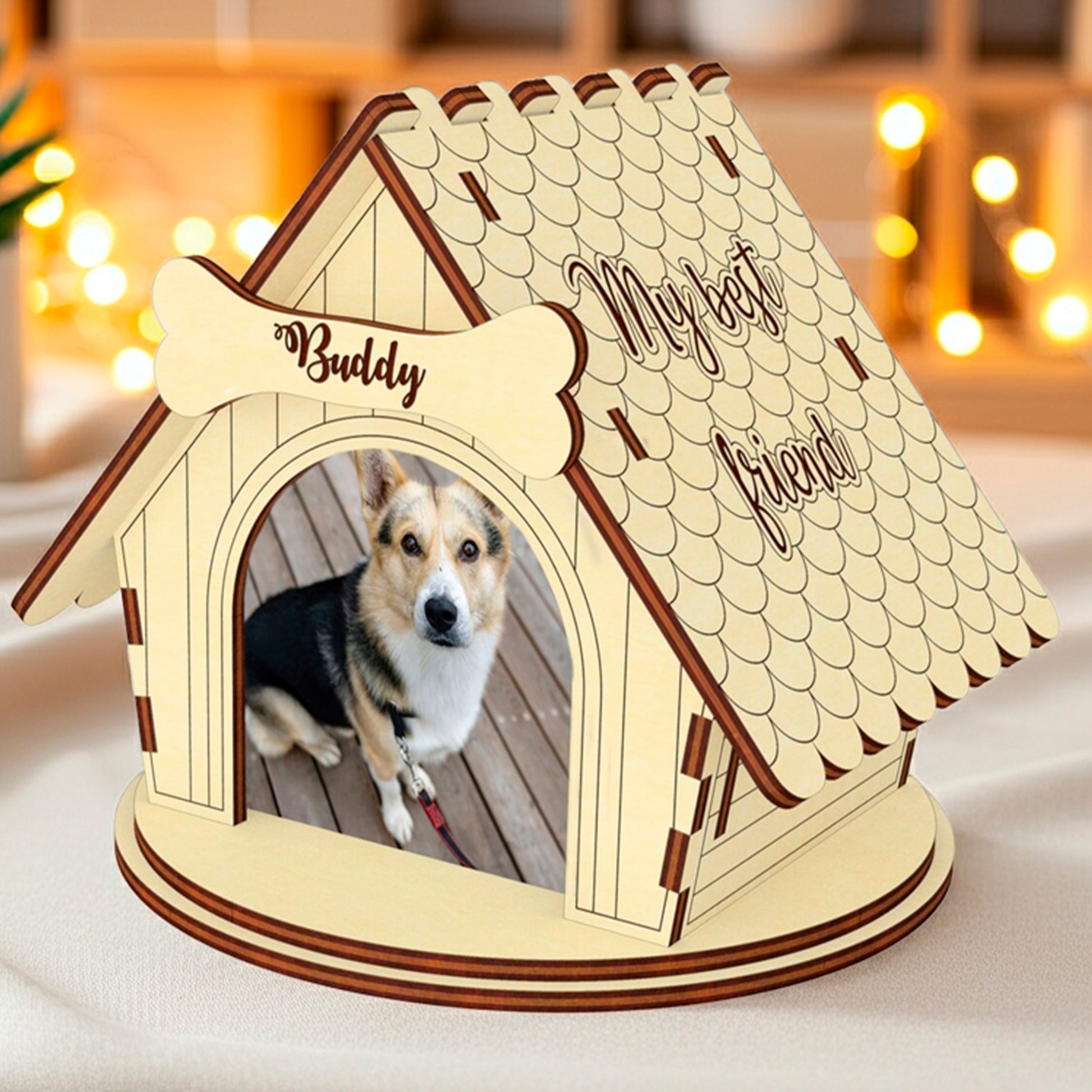 Laser cut wooden plywood dog house photo frame displaying a dog photo inside. The roof has an intricate scalloped shingle design with the inscription "My best friend" etched into the side, emphasizing the personalized pet memorial or gift aspect. A bone name tag is visible above the door.