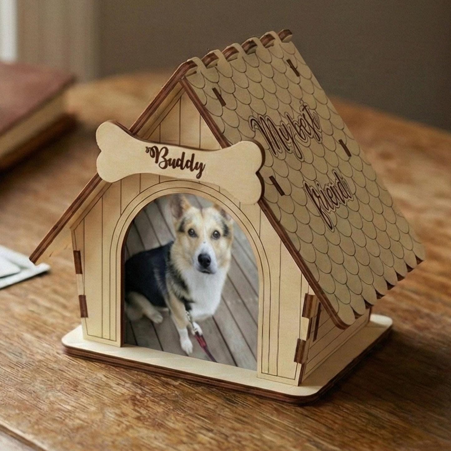 Wooden laser cut doghouse-shaped photo frame with a dog inside on a wooden surface