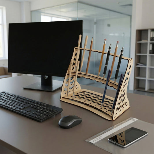 Elegant laser cut wooden pen stand in light finish featuring decorative cutouts, displayed with assorted writing tools on a workspace setting.