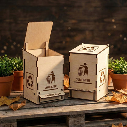 Two laser cut plywood miniature dumpsters side-by-side on a wooden pallet; one is open and one is closed. Highlights the detailed engravings and functional lever mechanism. Perfect for a unique office desk organizer or trash bin.