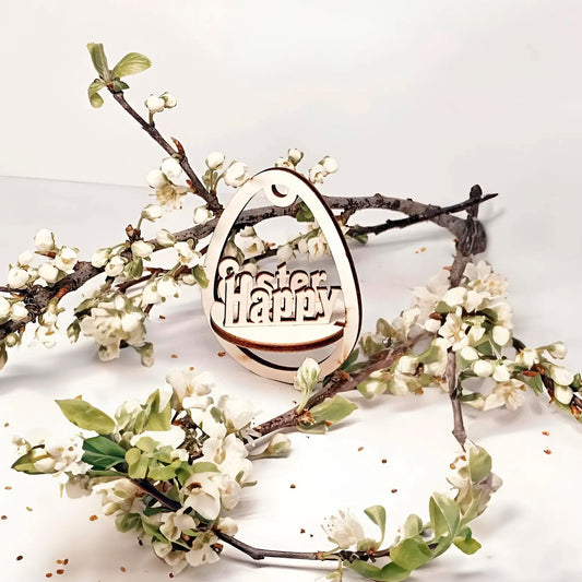 Laser cut plywood wooden Easter egg ornament with the layered, etched text "Happy Easter" inside, hanging among white blooming spring tree branches on a clean white background