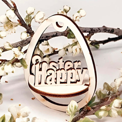 Laser cut plywood wooden Easter egg ornament with the layered, etched text "Happy Easter" inside, hanging among white blooming spring tree branches on a clean white background