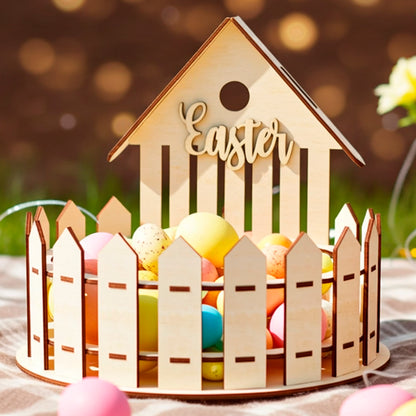 Laser cut wooden plywood fence house basket filled with pastel eggs, sitting on a plaid blanket on green grass, with blurred golden bokeh lights and a basket of yellow flowers nearby.