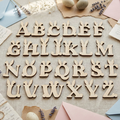 Wooden laser cut letters on a textured surface with decorative elements