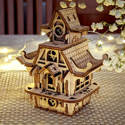 Charming laser cut plywood fairy house on a textured surface. Perfect miniature home with intricate wooden details.