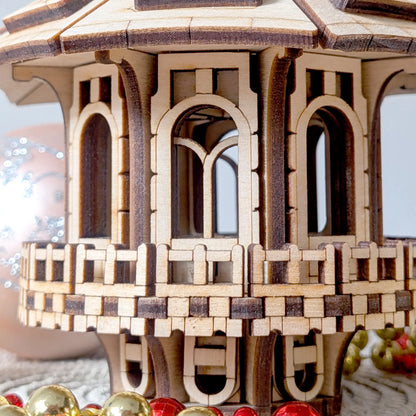 Macro close up focusing on the geometric balcony railing and miniature arched windows of a laser cut plywood fairy house