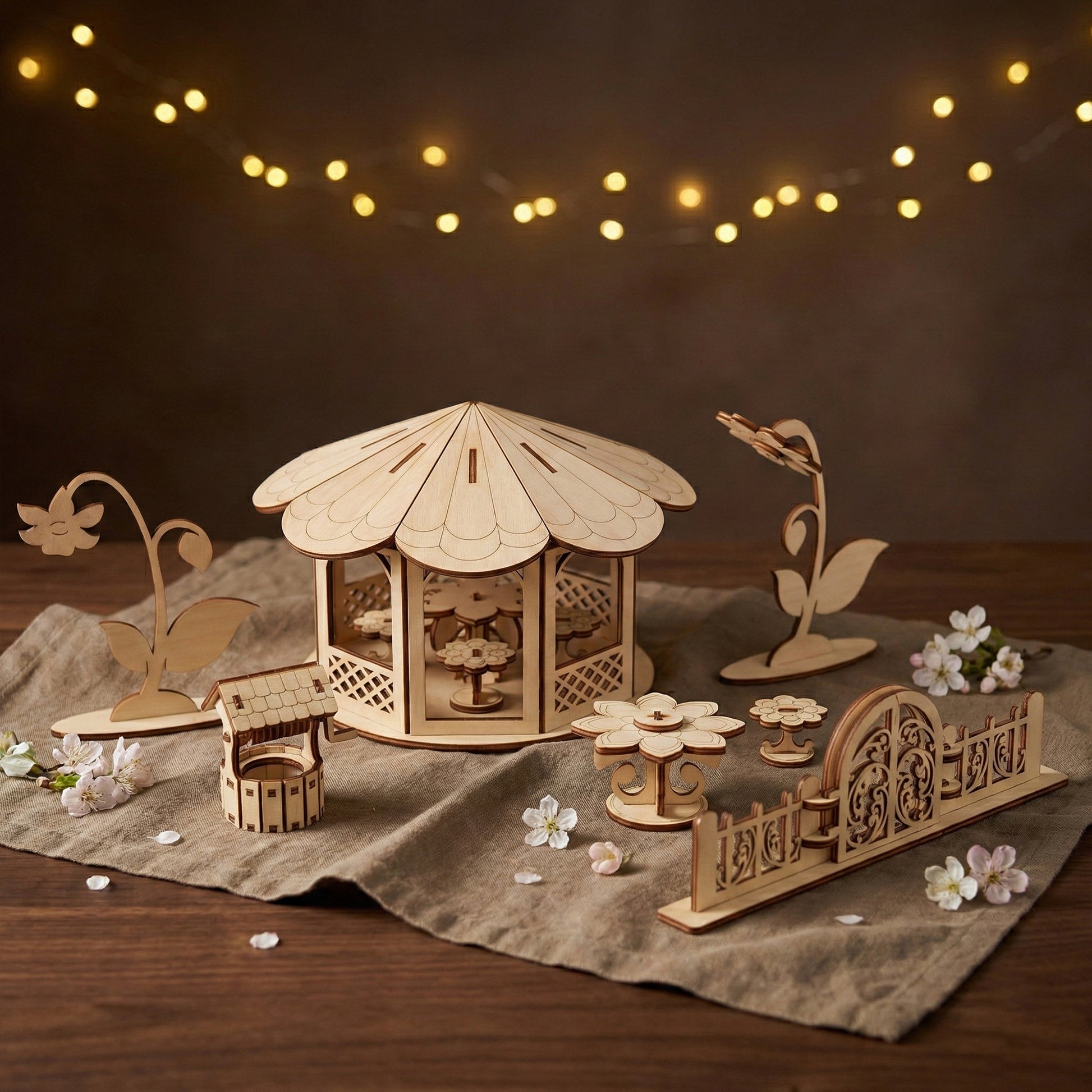 Full set of miniature garden accessories crafted from laser cut plywood. Features a detailed gazebo with flower tables inside. The natural birch wood grain and dark burnt edges provide a rustic, whimsical look for dollhouses.