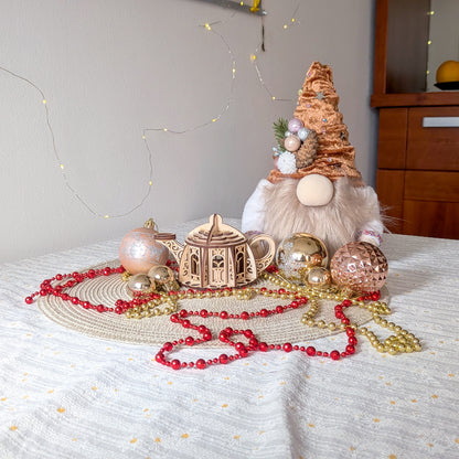 Fairy kettle house laser cut model displayed in a cozy holiday setup with ornaments, beads, and a Christmas gnome