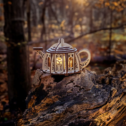 Fairy kettle house made from laser cut plywood glowing with LED lights, photographed in a magical forest at golden hour