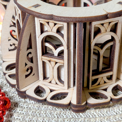 Close-up of the intricate laser cut window and ornate decorative patterns of the wooden fairy kettle house
