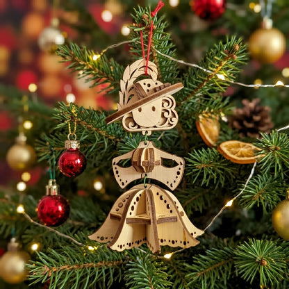 Wooden laser cut fairy ornament on a Christmas tree with lights and decorations.